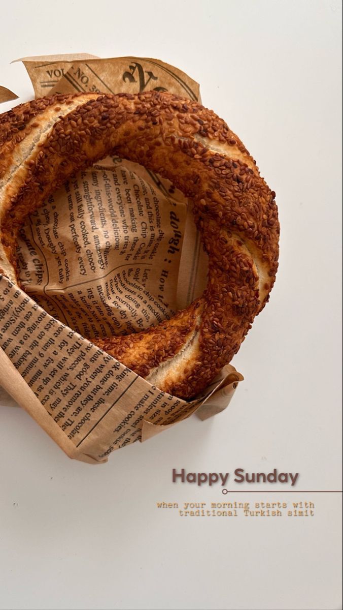 a piece of bread sitting on top of an old book page with the words happy sunday written in it