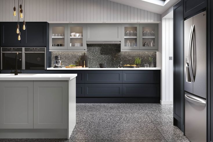 a modern kitchen with black cabinets and stainless steel appliances