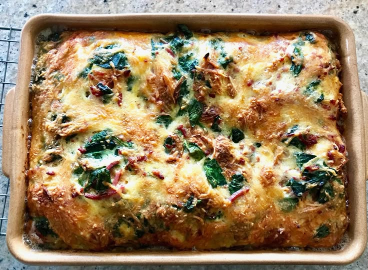 a casserole dish with spinach and cheese