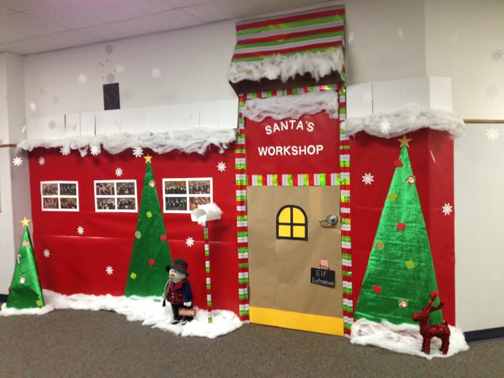 an office decorated for christmas with santa's workshop on the front door and decorations