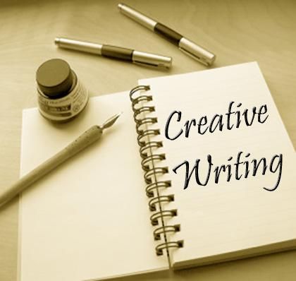 a notepad with the words creative writing on it next to some pens and ink