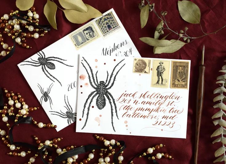 two envelopes, one with a spider on it and the other with writing in calligraphy