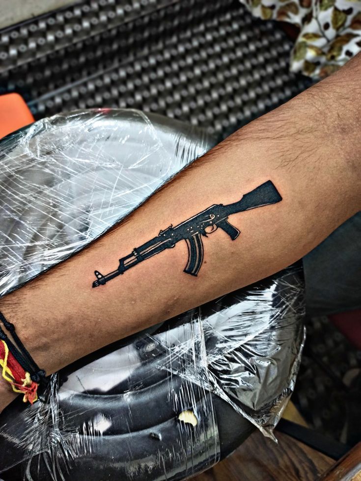 210+ Powerful Gun Tattoo Designs (2023) - TattoosBoyGirl Tattoo Ak47, Shotgun Tattoo, Ak47 Tattoo, Revolver Tattoo, Tattoo On Hand, Gangsta Tattoos, Tattoo Pictures, Tattoo Art Drawings, Phone Wallpaper For Men