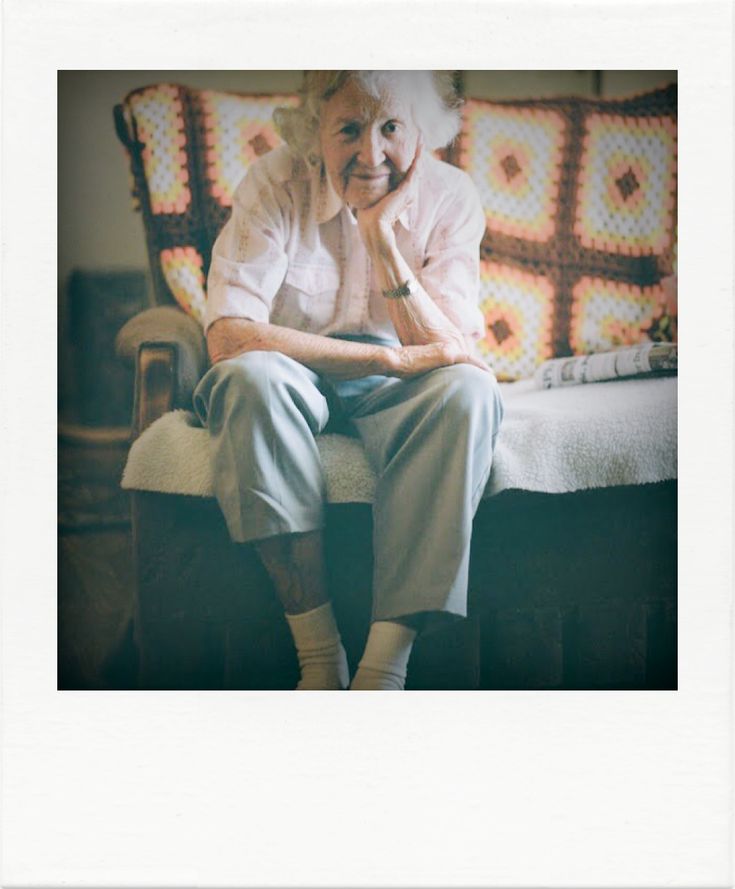 an older woman sitting on top of a chair