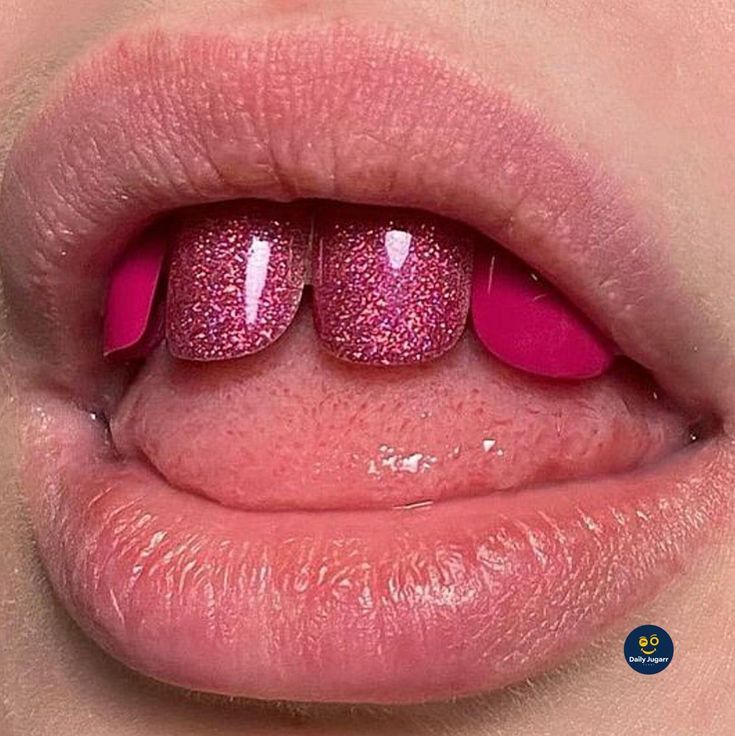 a woman's lips with pink glitters on the top and bottom part of her tongue