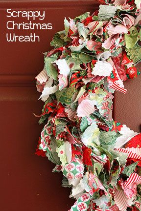 a christmas wreath hanging on the side of a door with words scrappy christmas wreath