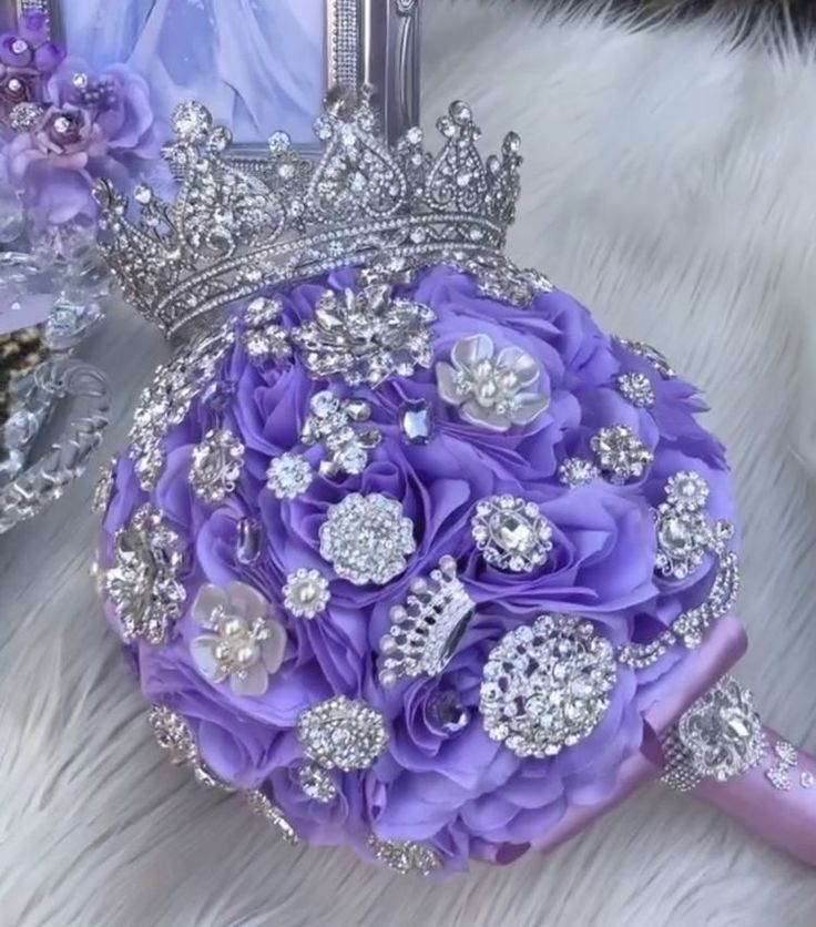 a purple bridal bouquet sitting on top of a white fur covered floor next to a mirror