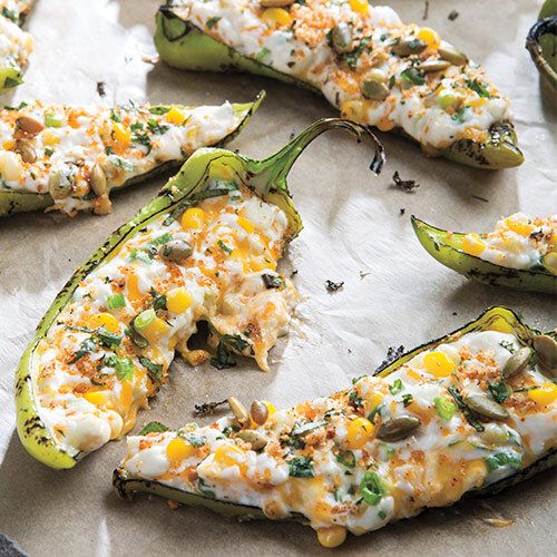 stuffed bell peppers with cheese and herbs on parchment paper