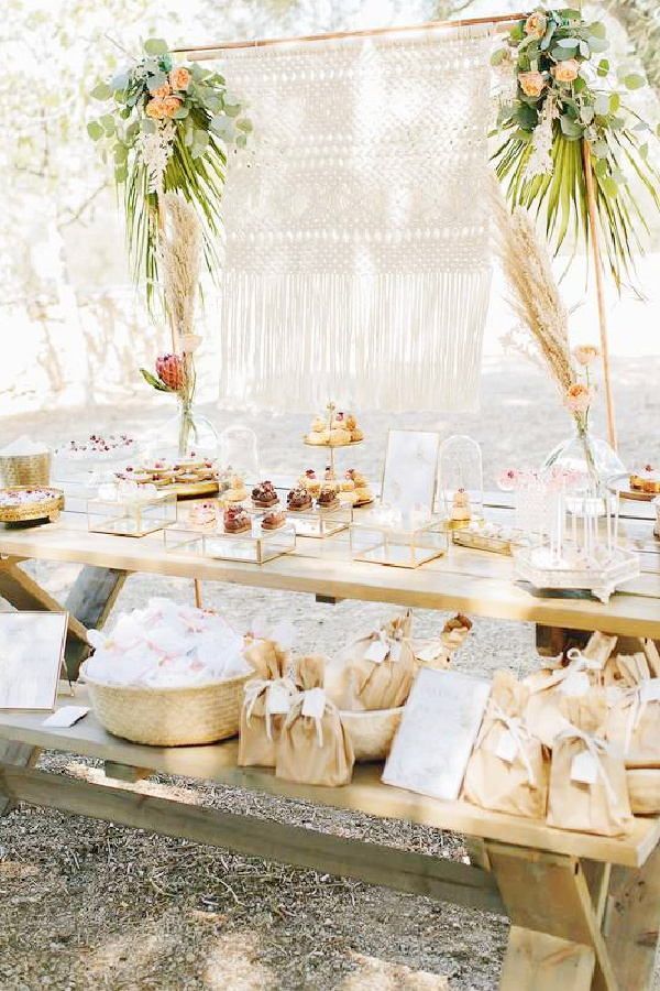 a table topped with lots of desserts under a canopy