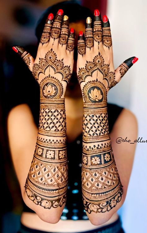 a woman with her hands covered in henna