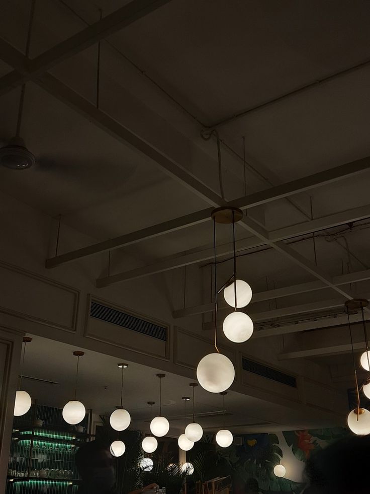 several lights hanging from the ceiling in a restaurant