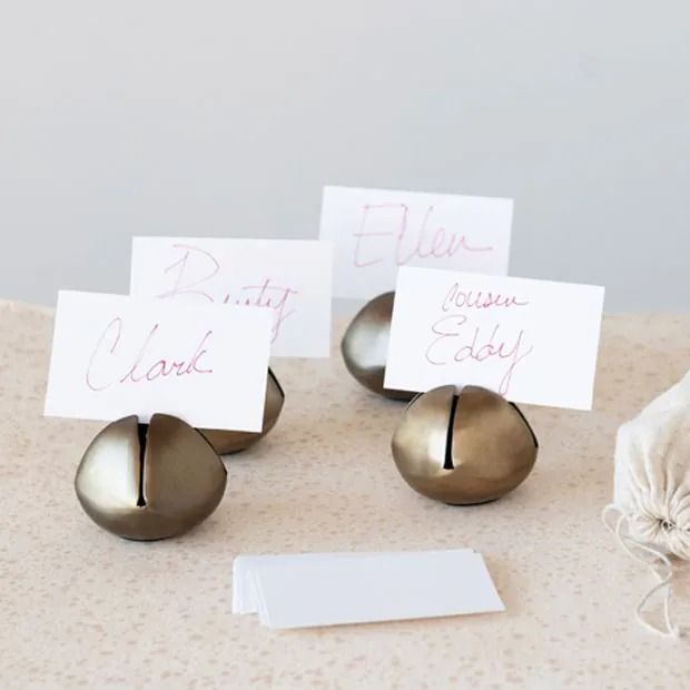 three place cards are placed on some metal balls