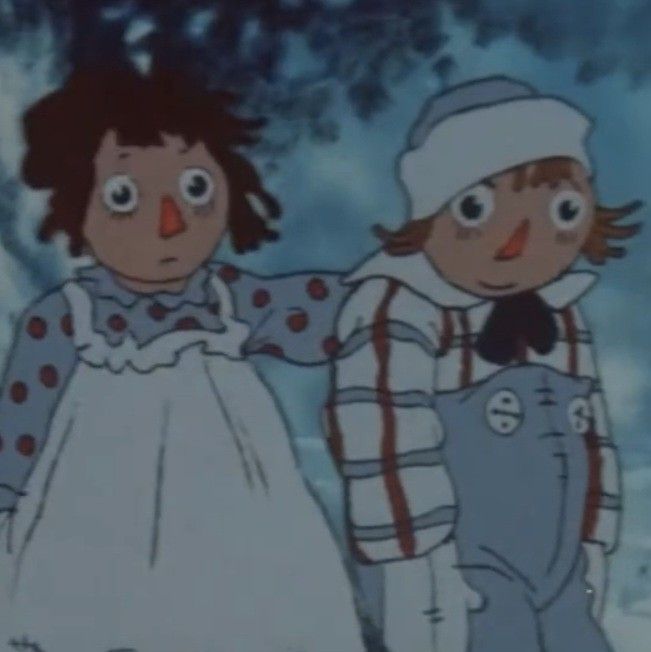 two children dressed up in old fashioned clothing standing next to each other on snow covered ground