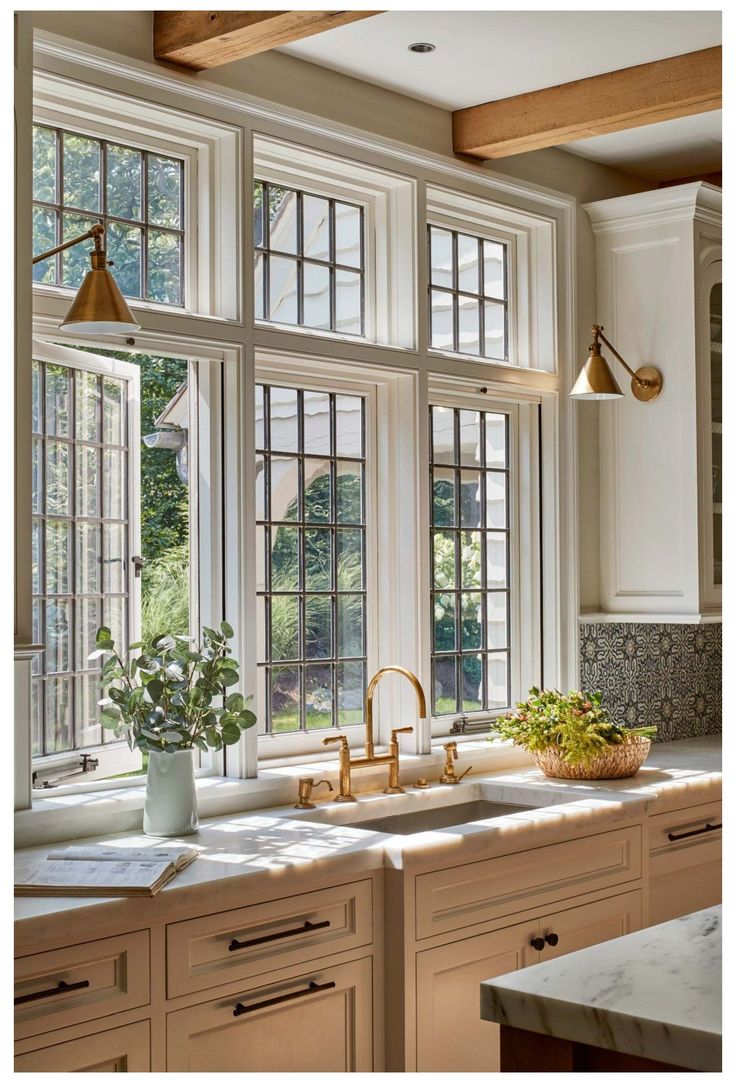 a kitchen filled with lots of windows next to a sink