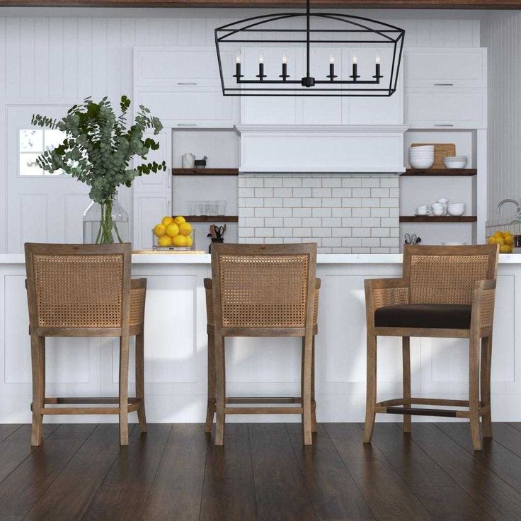 a kitchen with white walls and wooden floors