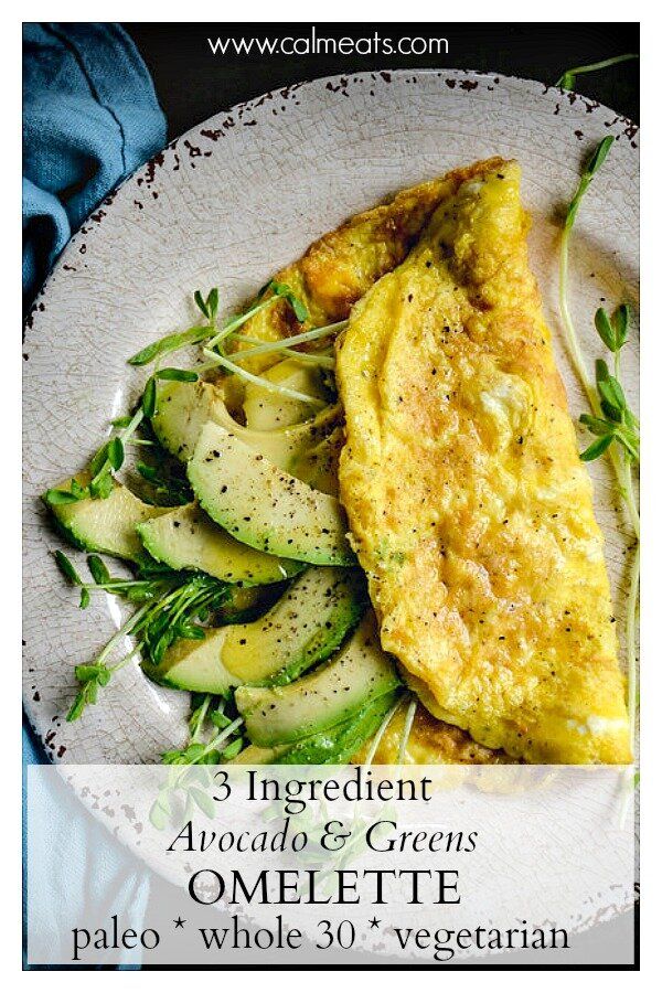 an omelette on a white plate with green garnish and some herbs