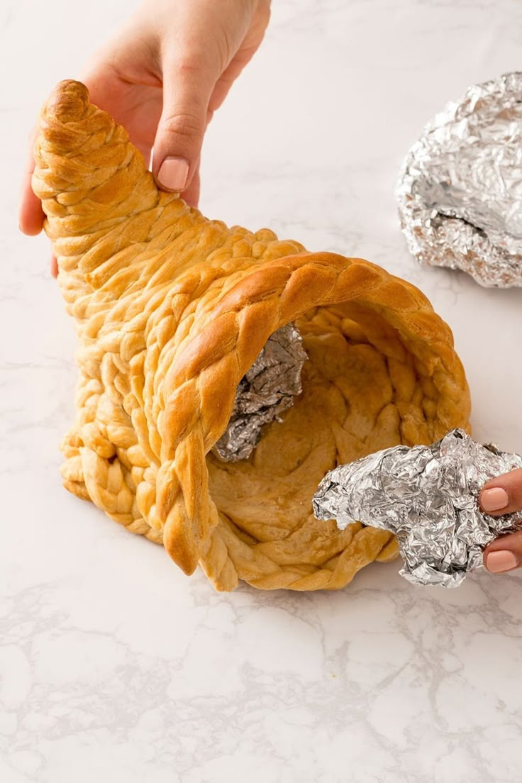 a person is holding some food in their hand and it looks like they are wrapped in tin foil