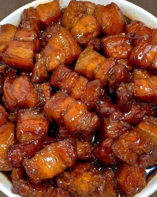 a white bowl filled with cooked food on top of a table