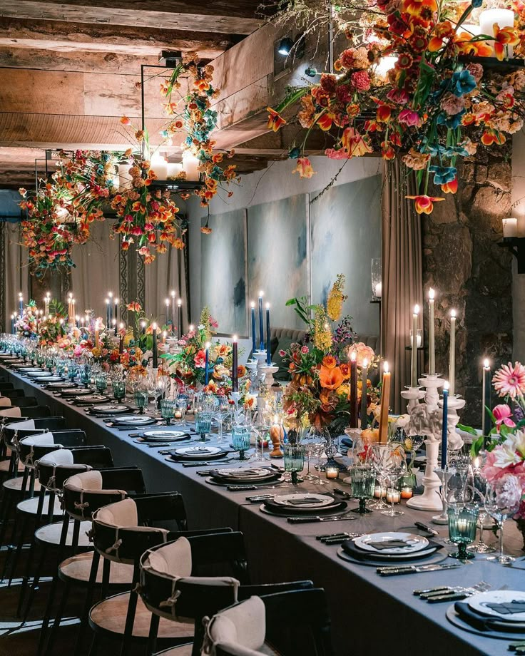 a long table is set up with flowers and candles for an elegant dinner or party