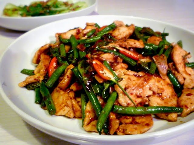 a white plate topped with chicken and green beans