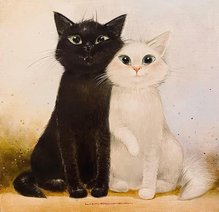 two black and white cats sitting next to each other