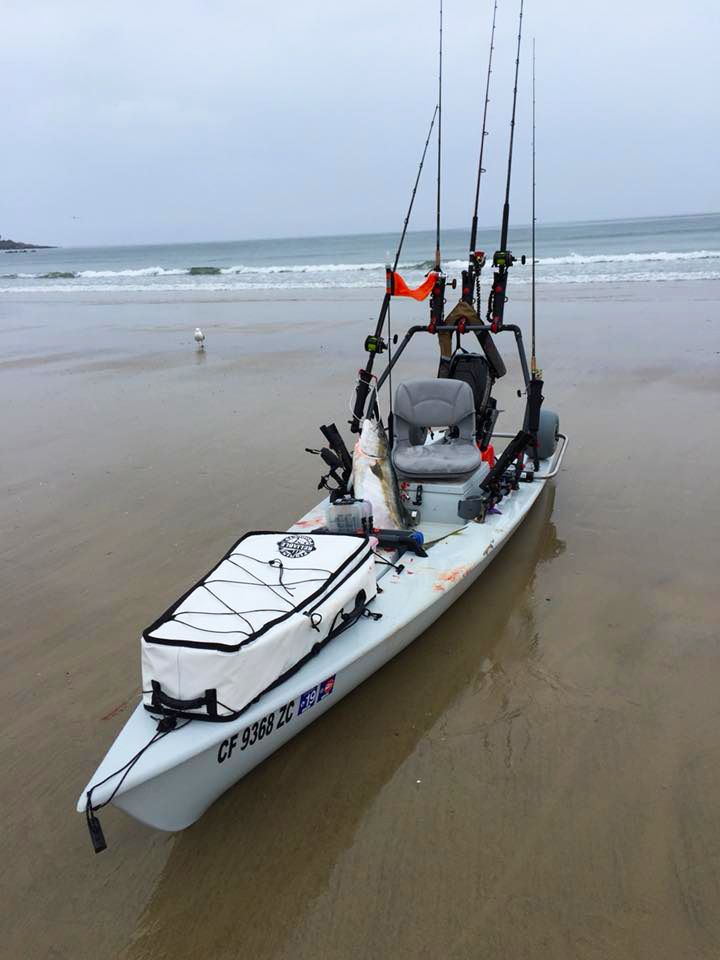 a white kayak with two men on it and fishing rods attached to the front