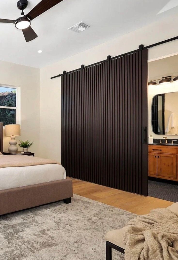 a bedroom with a large bed and sliding doors