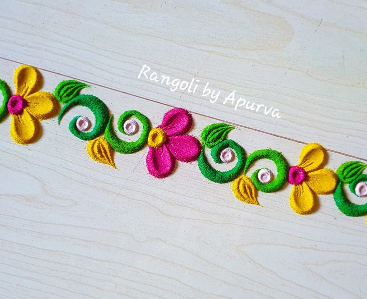 an embroidered ribbon with flowers and leaves is shown on a wooden surface, along with the words ranggol by apurva