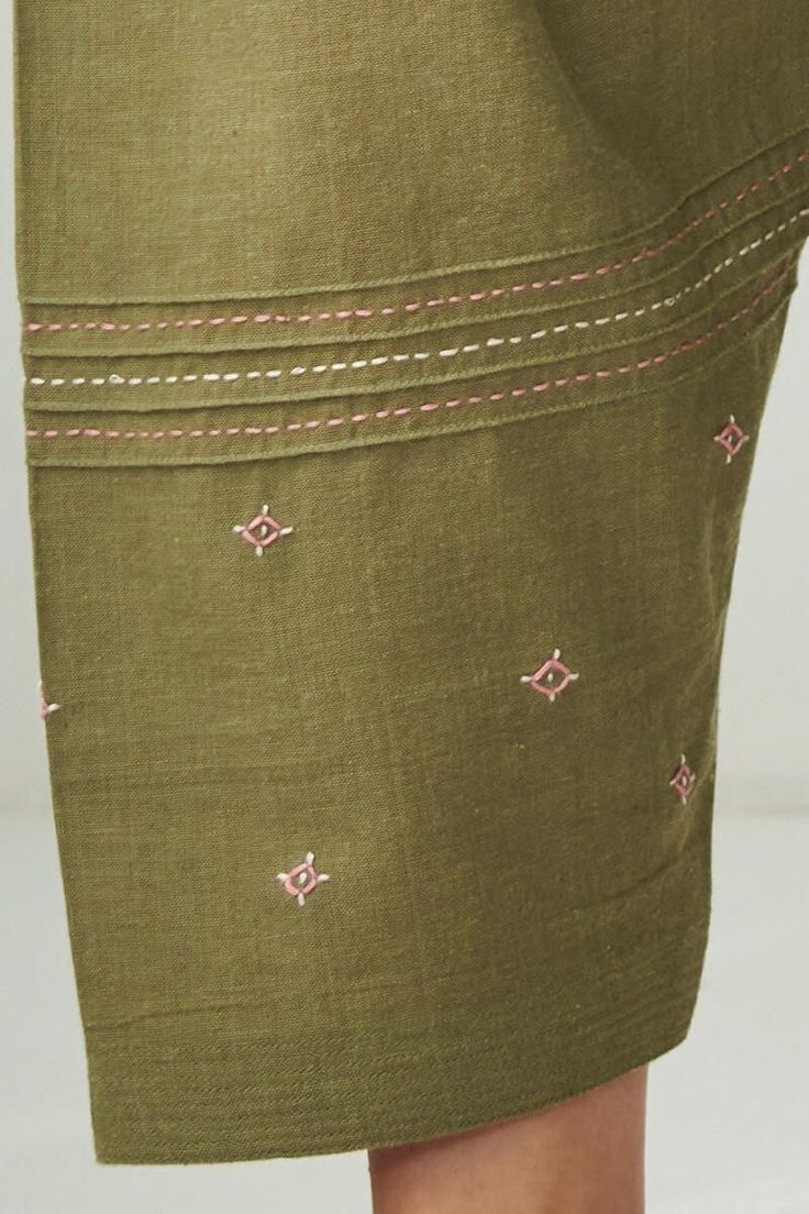 a woman's green skirt with pink trimmings