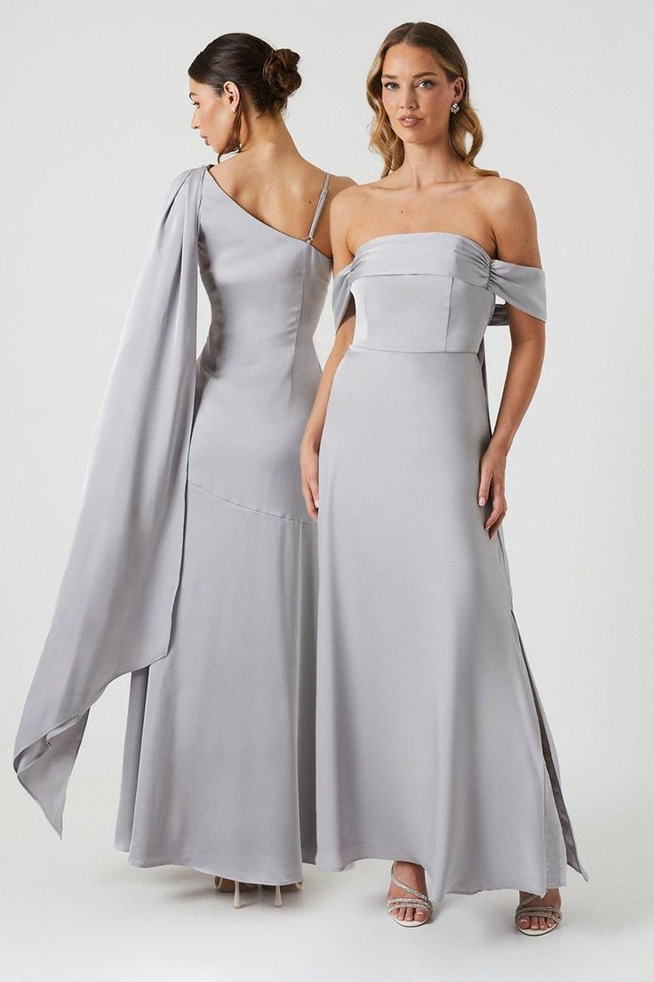 two women in grey dresses standing side by side, one is wearing an off the shoulder dress