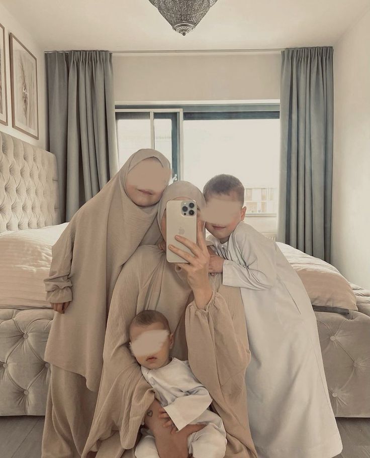 a man taking a selfie with two women and a baby in front of him