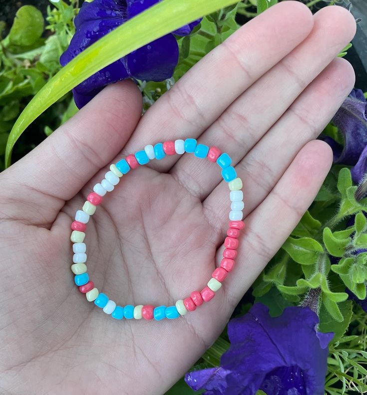 Coral, blue, white, and tan seed bead bracelet. Made to fit average teen wrist. Casual Beach Bracelets With Spacer Beads, Casual Summer Beaded Bracelets With Round Beads, Casual Stretch Bracelet With Tiny Beads For Summer, Blue Beaded Stretch Bracelet For Summer, Casual Beach Bracelet Beads, Casual Beaded Bracelets With Heart Beads For Friendship, Casual Summer Beaded Bracelets, Casual Turquoise Beaded Bracelets With Spacer Beads, Casual Multicolor Beaded Bracelets