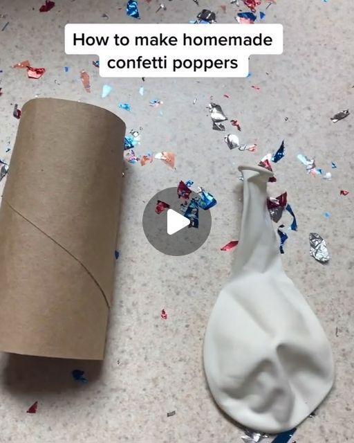 a roll of toilet paper sitting on top of a floor next to a cup filled with confetti