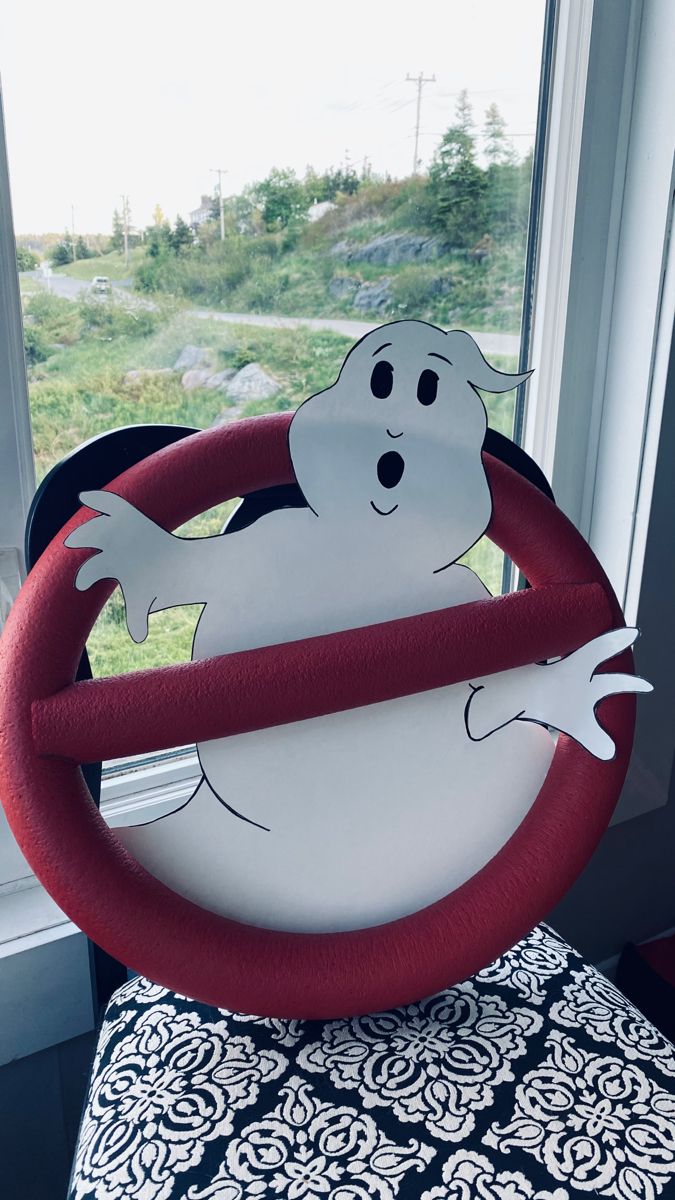 a paper plate with a ghost on it sitting in front of a window