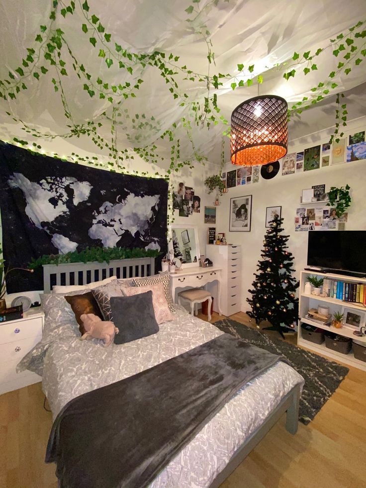 a bed room with a neatly made bed and a christmas tree on the wall next to it