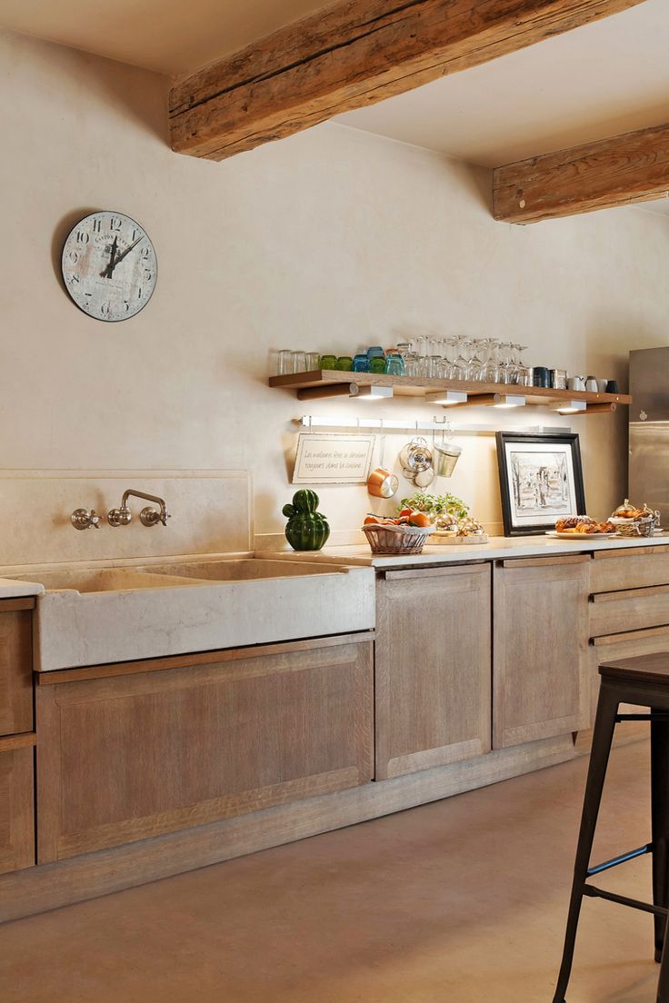 a kitchen with a clock on the wall