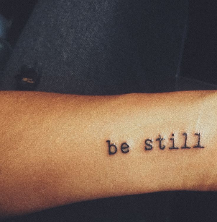 a person's arm with the words be still written on it, in black ink