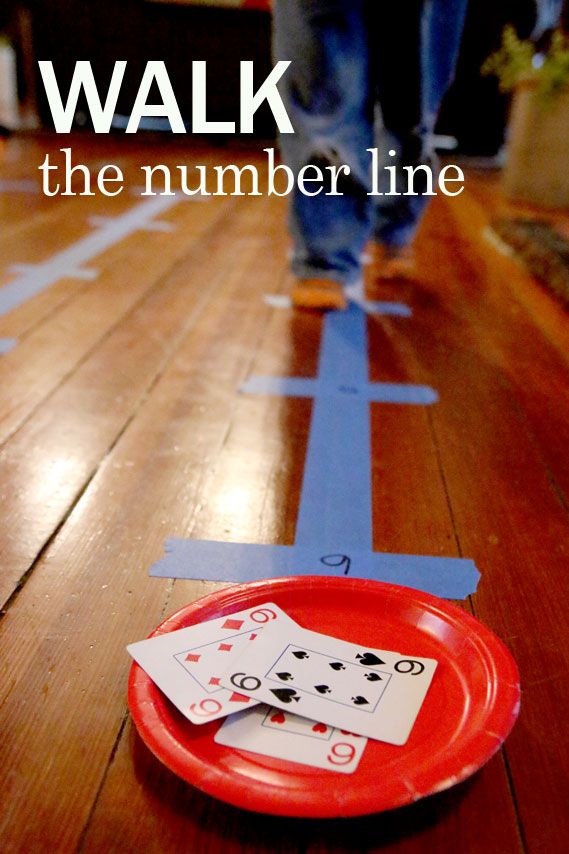 a red plate sitting on top of a wooden floor with playing cards in front of it