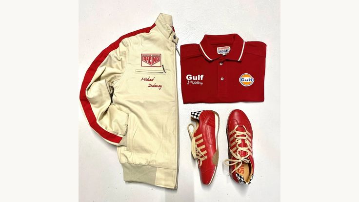 a pair of red tennis shoes next to a white jacket and some other items on a table