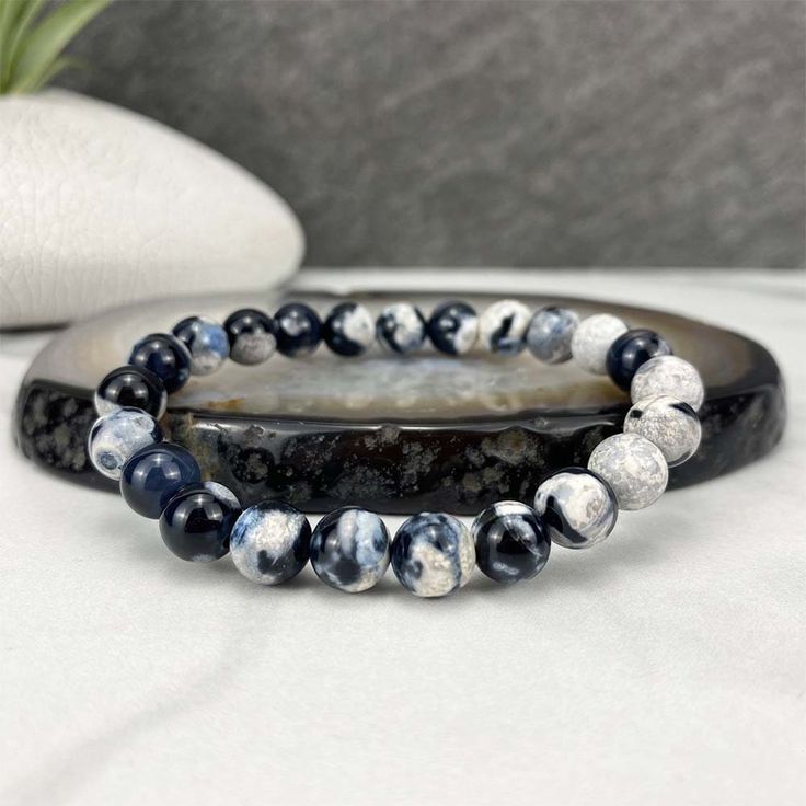 "Polished beads made from orca agate (thought to be a variety of blue chalcedony). 8mm Bracelets Sized: 6.50\" - 6.75\" Our crystals and minerals are natural, and some are shaped by hand. Because each is unique and one of a kind, some may come with small chips or imperfections. Any appearances of cracks are one of the natural characteristics of this crystal or mineral and not because of damage. We select all crystals and minerals by hand. We choose the most unique and highest quality we can find Casual Agate Beaded Bracelets With Gemstone Beads, Casual Agate Gemstone Beaded Bracelets, Adjustable Casual Agate Stretch Bracelet, Casual Adjustable Agate Stretch Bracelet, Casual Agate Beaded Bracelets With Round Beads, Casual Agate Beaded Bracelets, Casual Round Agate Beaded Bracelets, Casual Hand-strung Agate Bracelet, Casual Black Agate Beaded Bracelets