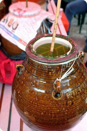 a brown vase sitting on top of a wooden table