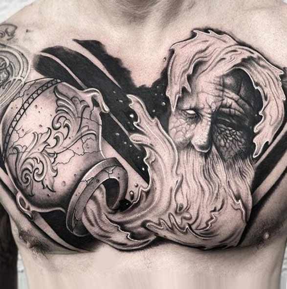 a man's chest with an artistic tattoo design on it