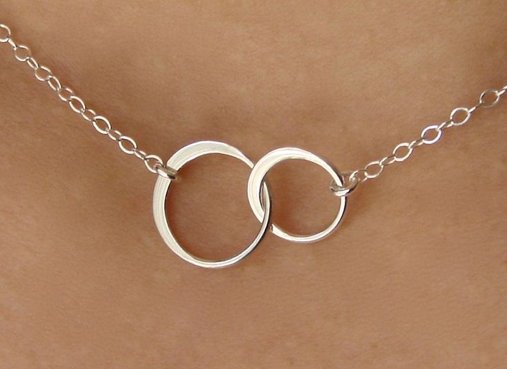 "Forever linked together, two cute tiny eternal circles form the center of this beautiful necklace. The two linked circles are in shining sterling silver and catch the light beautifully. At the center of a sterling silver chain and spring clasp, these symbols of eternity and love create a necklace of elegance, and simplicity. The sterling silver circles themselves measuring 19mm x 12mm or 1/2\" x 3/4\". ( small circle measures 10mm x 10mm or x 3/8\" x 3/8\" ; bigger circle measures 12mm x 12mm o Summer Honeymoon, Linked Rings, Double Circle Necklace, Bling Things, Interlocking Rings, Interlocking Circle Necklace, Interesting Jewelry, Bridesmaid Necklace Gift, Honeymoon Style