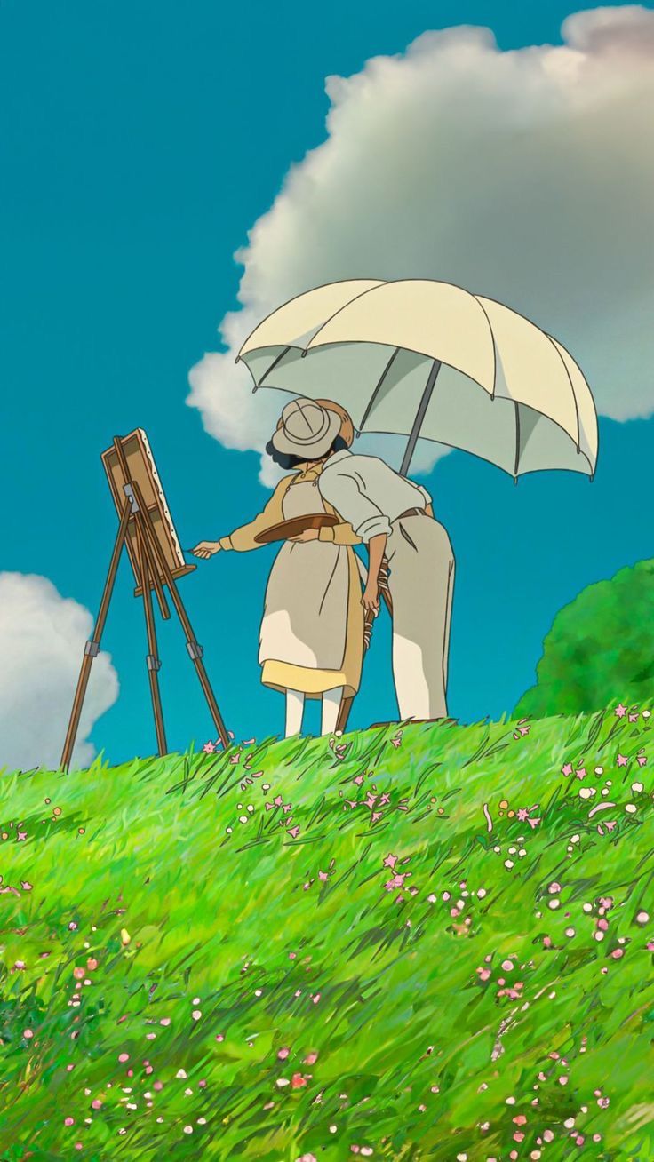 two people standing under an umbrella on top of a grass covered hill next to a easel