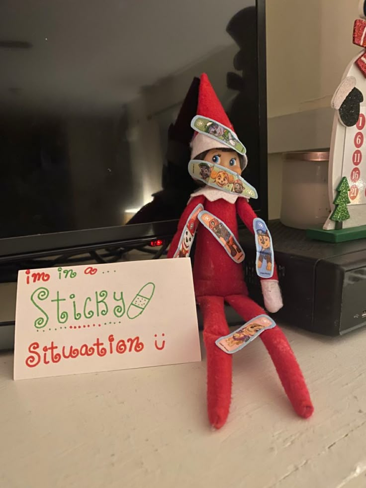 an elf is sitting on the counter next to a sign that says, i'm too stinky stillwatertonu