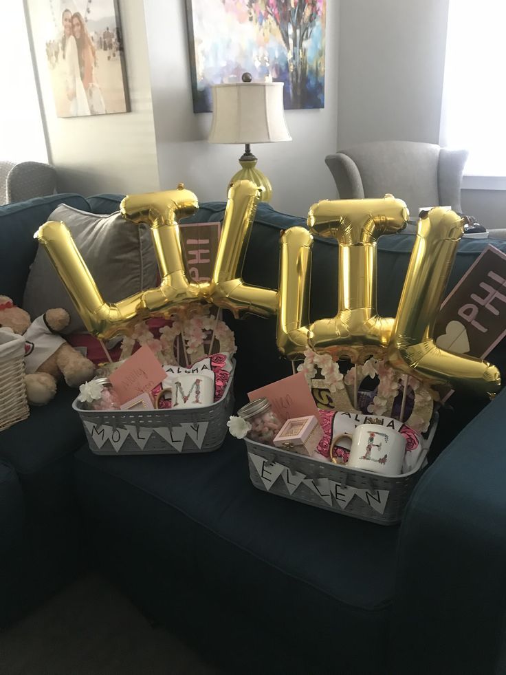 two baskets filled with items sitting on top of a blue couch