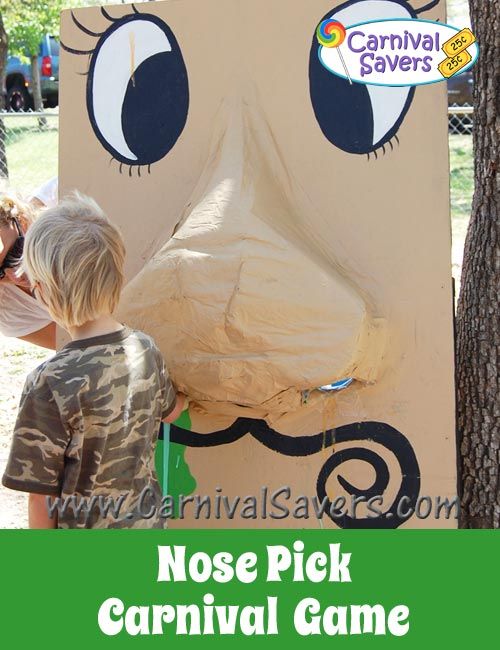 two children playing with nose pick carnival game at carnival savers in north carolina, usa