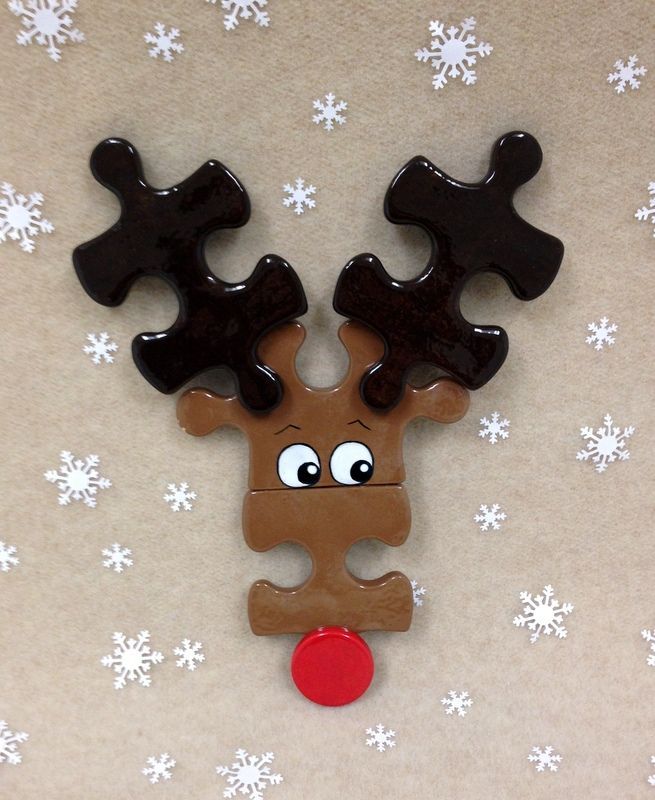 a wooden reindeer ornament on a white and brown background with snowflakes