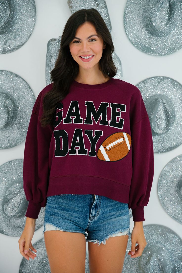 This maroon and black GAME DAY VARSITY PULLOVER is perfect for any sports fan. Made with ultra soft fabric and classic varsity letters, this pullover features a football patch for an extra touch of sporty spirit. Shop now and show off your team pride! All orders are currently shipping within 14 business days. To receive item quicker, expedited shipping is available at checkout. Fall Varsity Sweatshirt With Team Logo, Fall Varsity Sweatshirt, Team-colored Sweatshirt With Team Logo For Fall, Team-colored Fall Sweatshirt With Team Logo, Team-colored Varsity Sweatshirt For Football Season, Collegiate Sweatshirt With Team Logo For Football Season, Collegiate Team-colored Sweatshirt For Fall, Collegiate Style Sweatshirt With Team Logo For Football Season, Collegiate Sweatshirt For Football Season