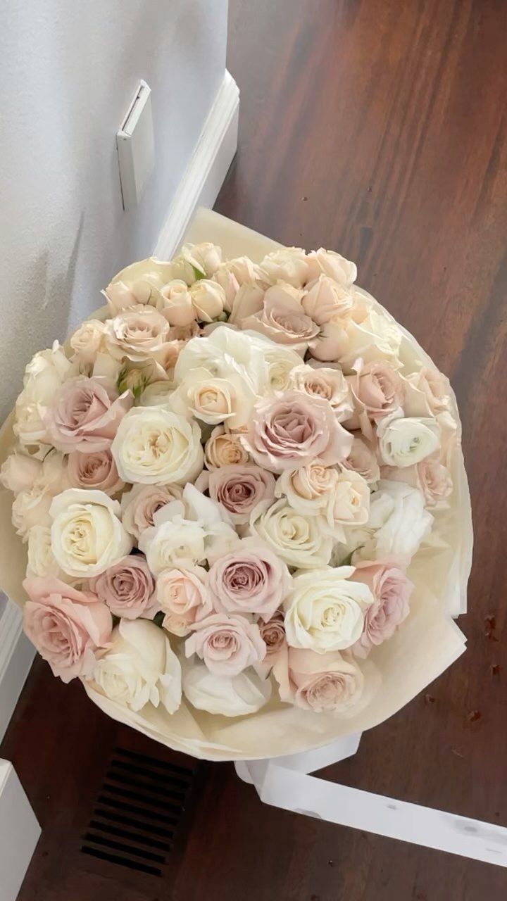 a bouquet of flowers sitting on top of a wooden floor next to a door way